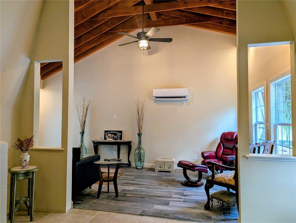18001 Nelson Road Spring Hill, FL 34610 - Photo 10 of 29 a living room with furniture and a chandelier