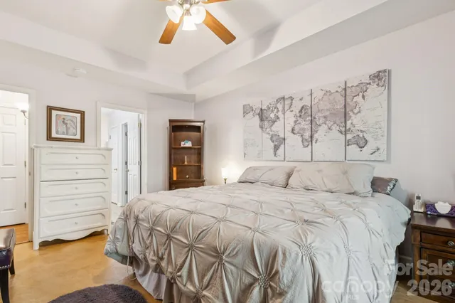 a bedroom with a bed and a chandelier