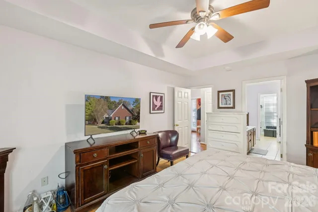 a bedroom with a bed and a chandelier