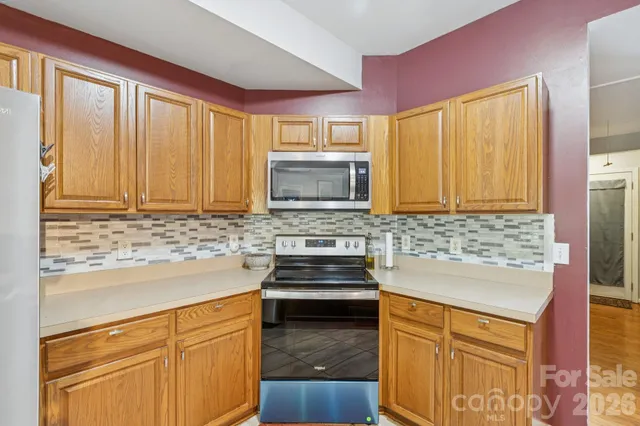 a large kitchen with a large counter top appliances and cabinets