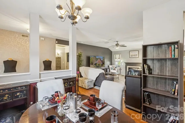 a view of a dining room with furniture and chandelier