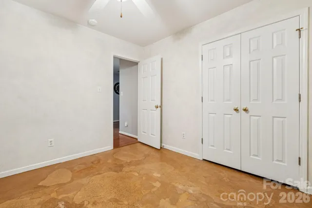 a view of a house with a yard and potted plants