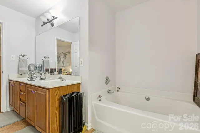 a view of a bedroom with furniture and windows