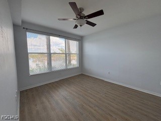 2615 Somerville Loop, Unit 303 Cape Coral, FL 33991 - Photo 15 of 40 an empty room with wooden floor and windows