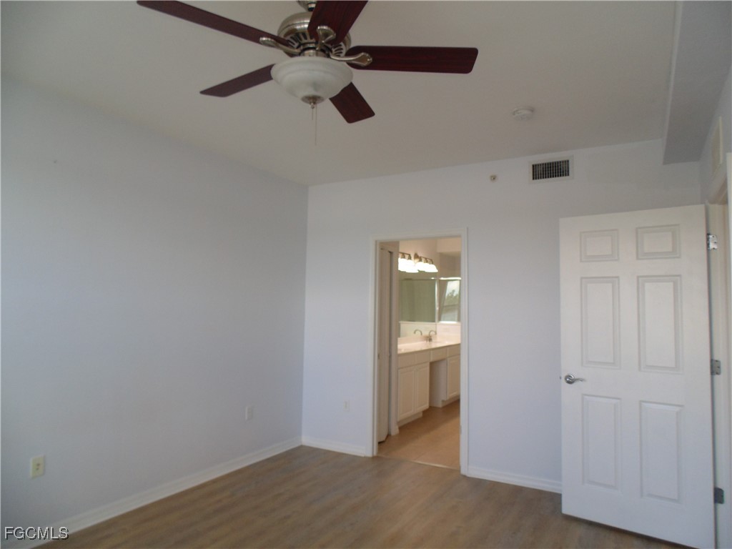 2615 Somerville Loop, Unit 303 Cape Coral, FL 33991 - Photo 16 of 40 wooden floor in an empty room