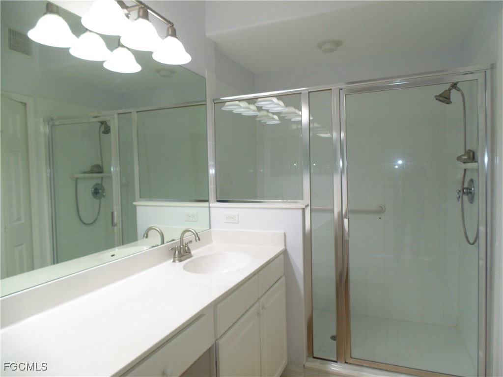 2615 Somerville Loop, Unit 303 Cape Coral, FL 33991 - Photo 18 of 40 a bathroom with a sink and a mirror