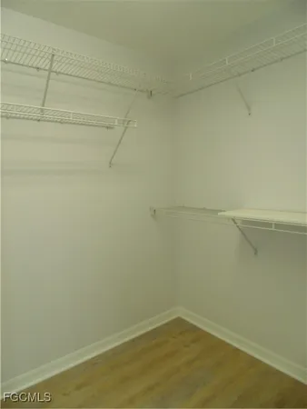 a white toilet sitting next to a white wall