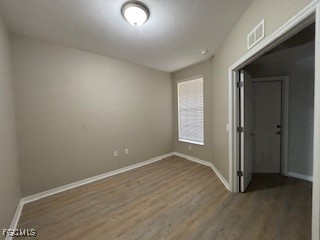 2615 Somerville Loop, Unit 303 Cape Coral, FL 33991 - Photo 29 of 40 an empty room with wooden floor and windows