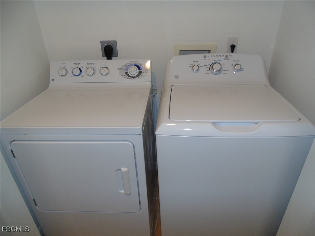 2615 Somerville Loop, Unit 303 Cape Coral, FL 33991 - Photo 30 of 40 a utility room with dryer and washer