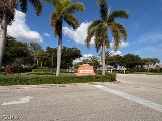 2615 Somerville Loop, Unit 303 Cape Coral, FL 33991 - Photo 32 of 40 a palm tree sitting in front of a house with a yard
