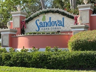 2615 Somerville Loop, Unit 303 Cape Coral, FL 33991 - Photo 33 of 40 a view of a house with a garden and signage