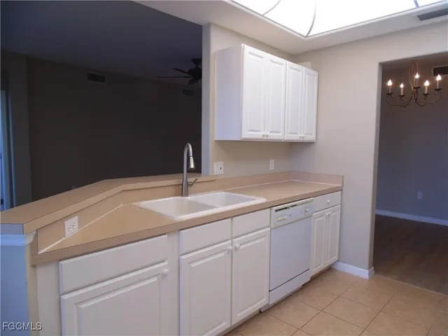 a kitchen with a sink and cabinets