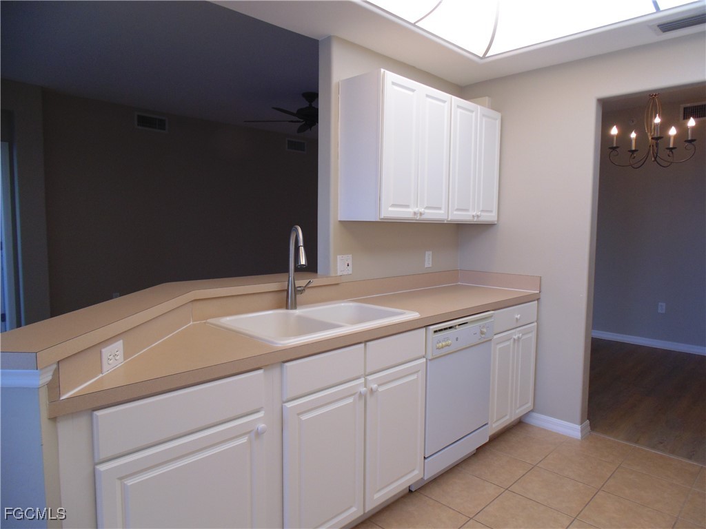 2615 Somerville Loop, Unit 303 Cape Coral, FL 33991 - Photo 5 of 40 a kitchen with a sink and cabinets