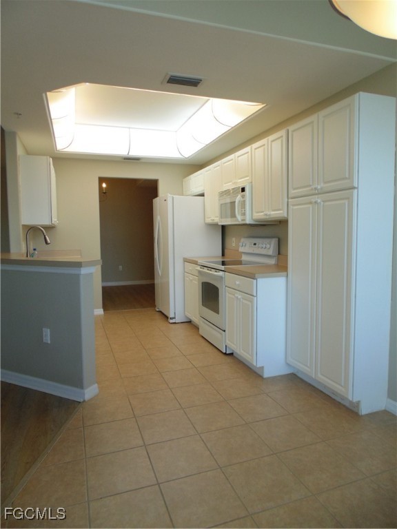 2615 Somerville Loop, Unit 303 Cape Coral, FL 33991 - Photo 7 of 40 a kitchen with stainless steel appliances granite countertop a stove a sink and a refrigerator