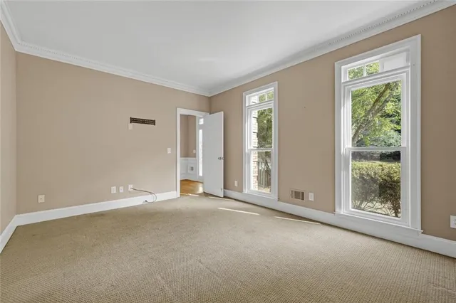 a view of empty room with wooden floor and ceiling fan