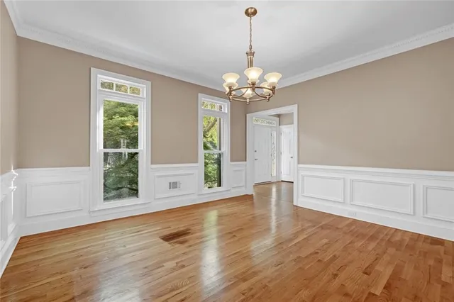 a view of an empty room with a fireplace and a window