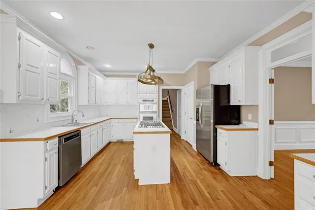 a view of a kitchen with microwave and refrigerator