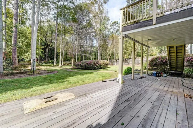 a view of balcony with wooden floor and fence