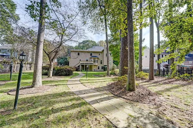 a view of a house with a yard and street