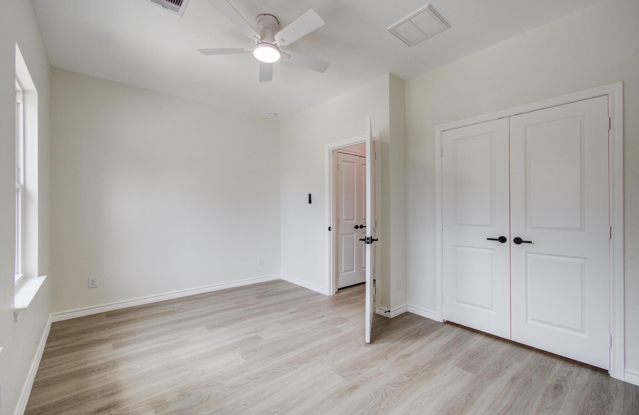 15301 Coaltown Road Willis, TX 77378 - Photo 29 of 38 an empty room with wooden floor and windows