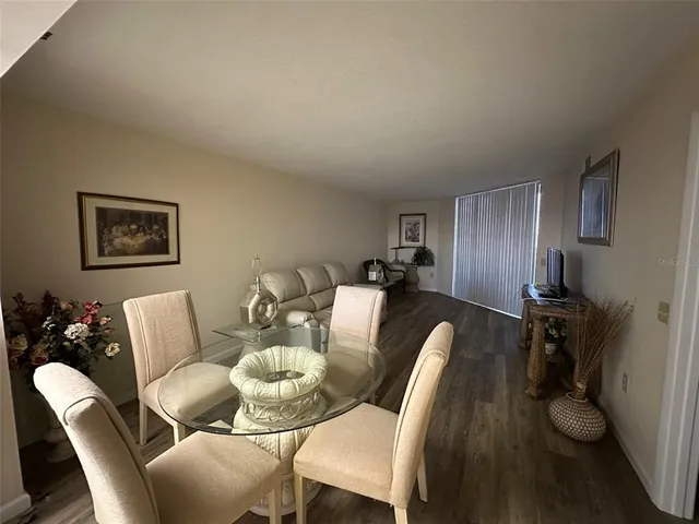 a kitchen with stainless steel appliances granite countertop a stove top oven a sink and a refrigerator