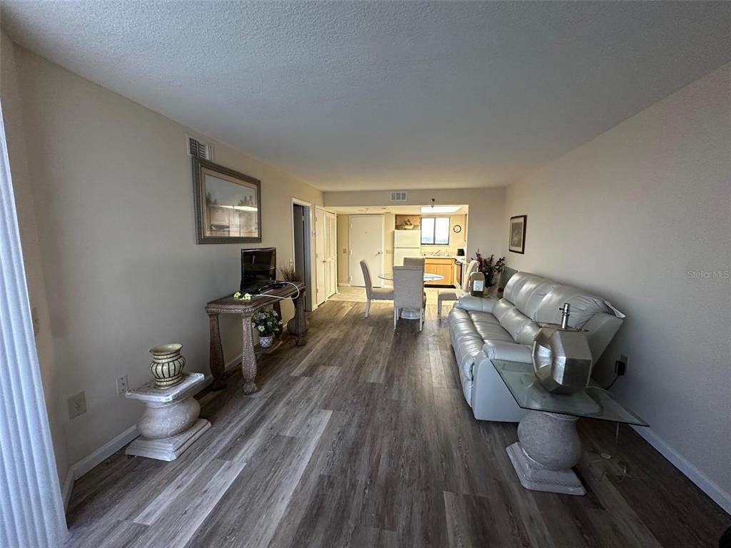 5915 Sea Ranch Drive, Unit 511 Hudson, FL 34667 - Photo 4 of 10 a living room with furniture and a wooden floor