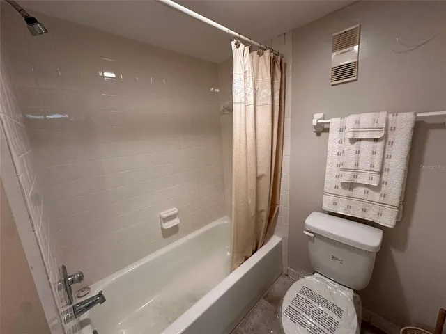 a bathroom with a sink and mirror with toilet