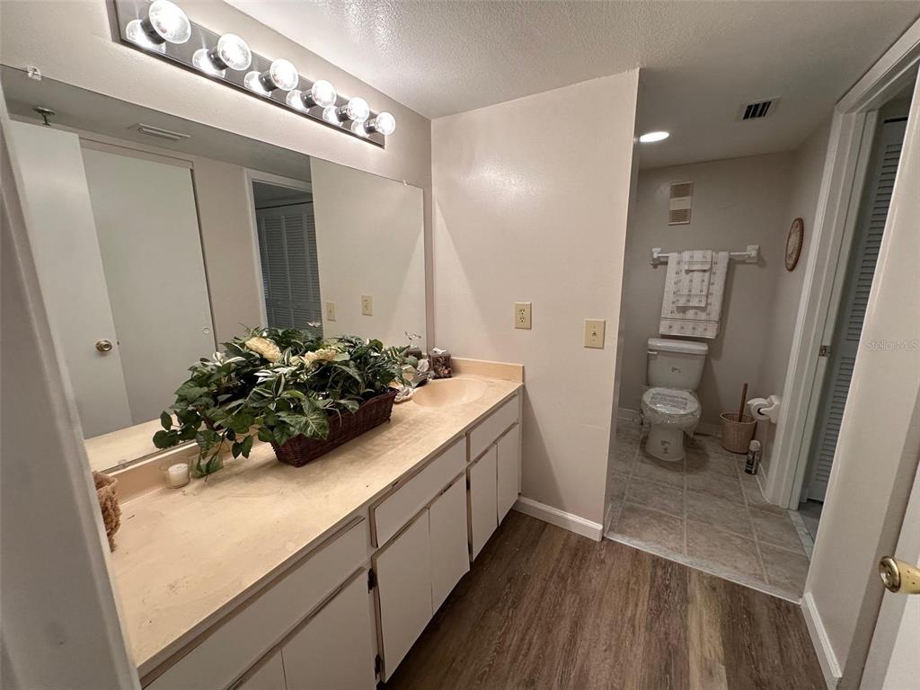 5915 Sea Ranch Drive, Unit 511 Hudson, FL 34667 - Photo 10 of 10 a bathroom with a sink and mirror with toilet