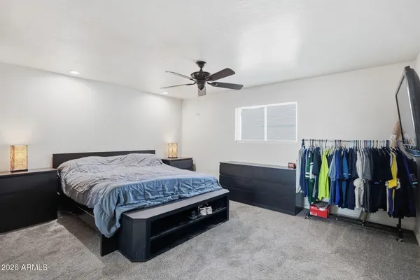 a bedroom with a bed and a chandelier