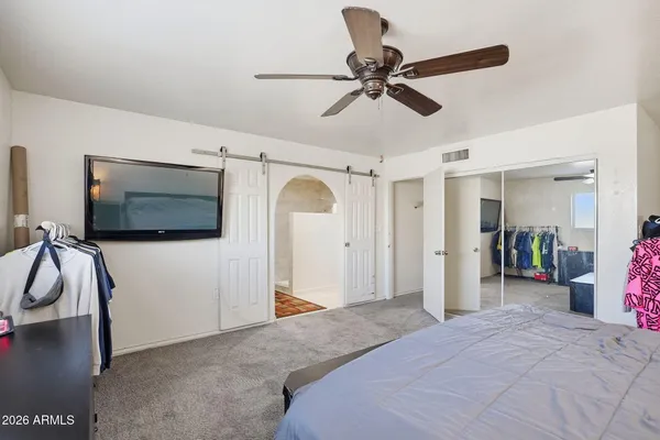 a bedroom with a bed and a television