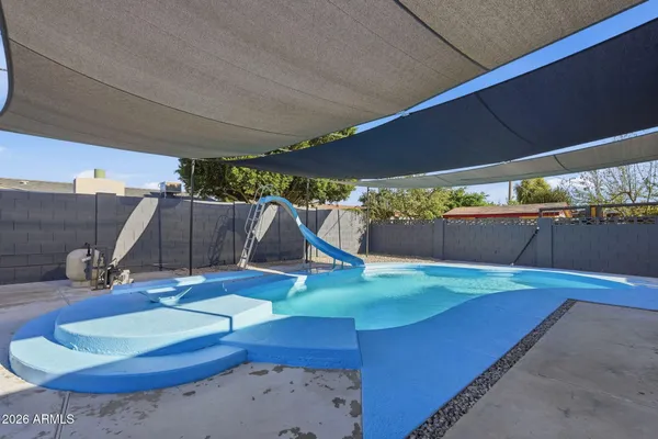 a view of a house with a backyard