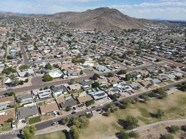 an aerial view of residential houses with outdoor space