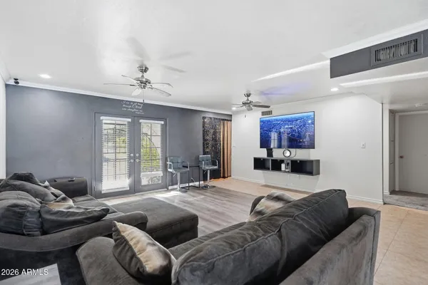 a living room with furniture and a flat screen tv