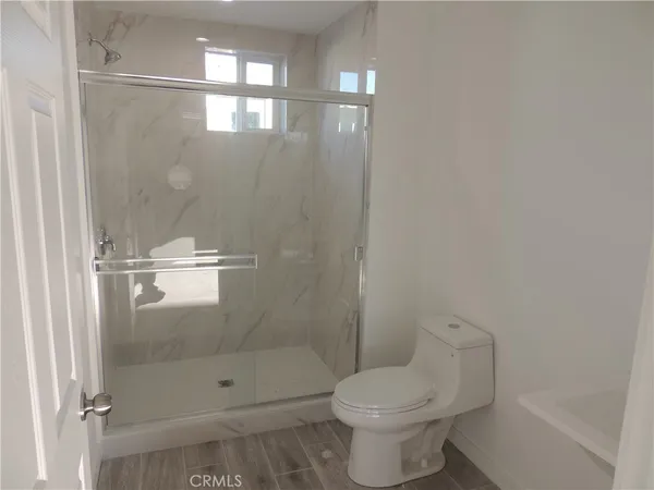 a bathroom with a shower and toilet