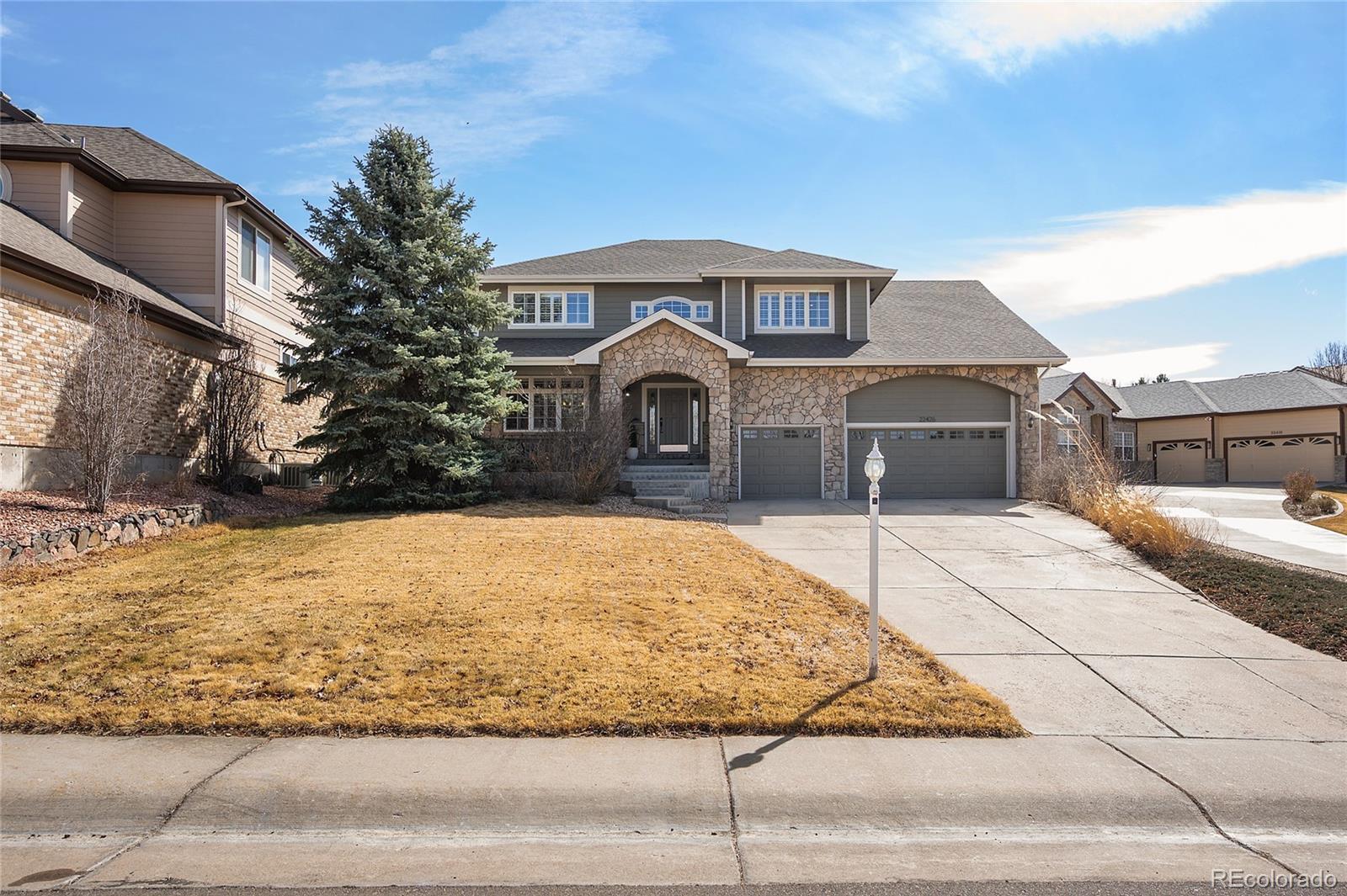22426 East Roxbury Place Aurora, CO 80016 - Photo 1 of 50 a front view of a house with a yard