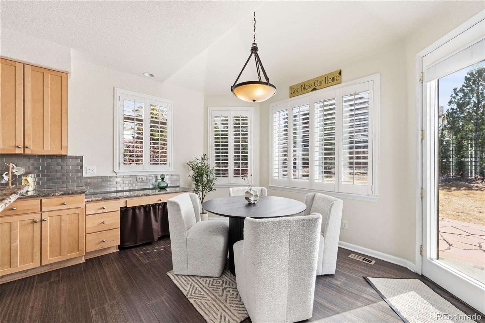 22426 East Roxbury Place Aurora, CO 80016 - Photo 17 of 50 a very nice looking dining room with a large window and wooden floor
