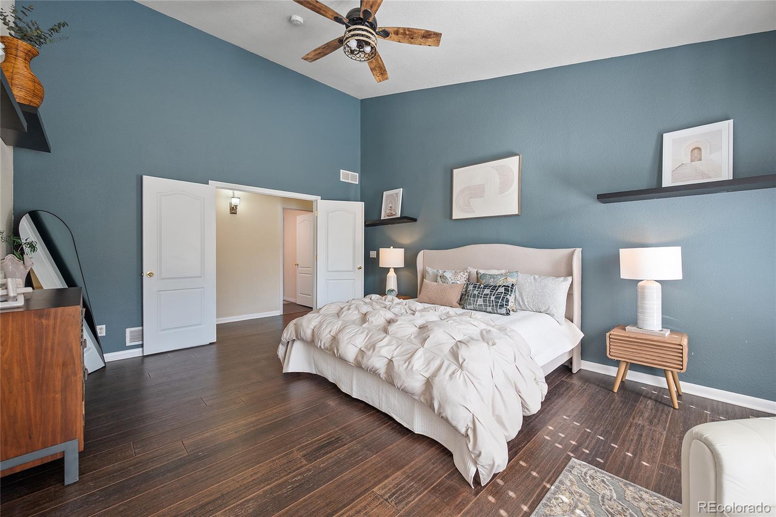 22426 East Roxbury Place Aurora, CO 80016 - Photo 24 of 50 a spacious bedroom with a bed and a table