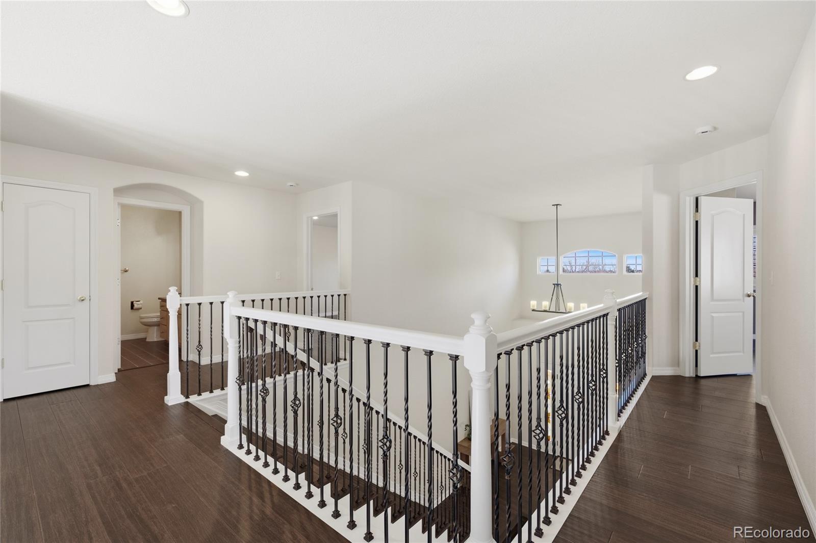 22426 East Roxbury Place Aurora, CO 80016 - Photo 40 of 50 a view of a hallway with a hardwood floor