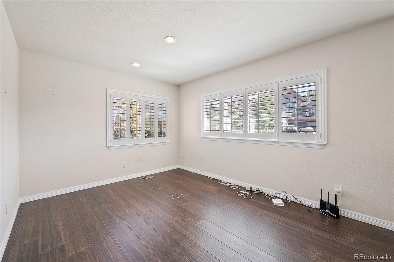 22426 East Roxbury Place Aurora, CO 80016 - Photo 41 of 50 a view of an empty room with wooden floor and a window