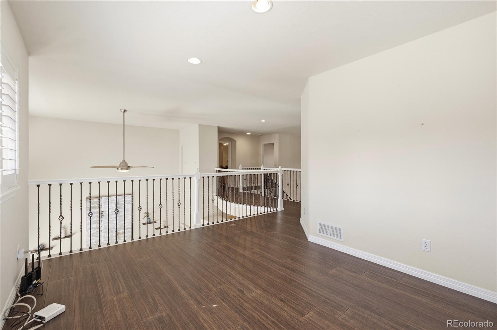 22426 East Roxbury Place Aurora, CO 80016 - Photo 42 of 50 a view of a hallway with wooden floor