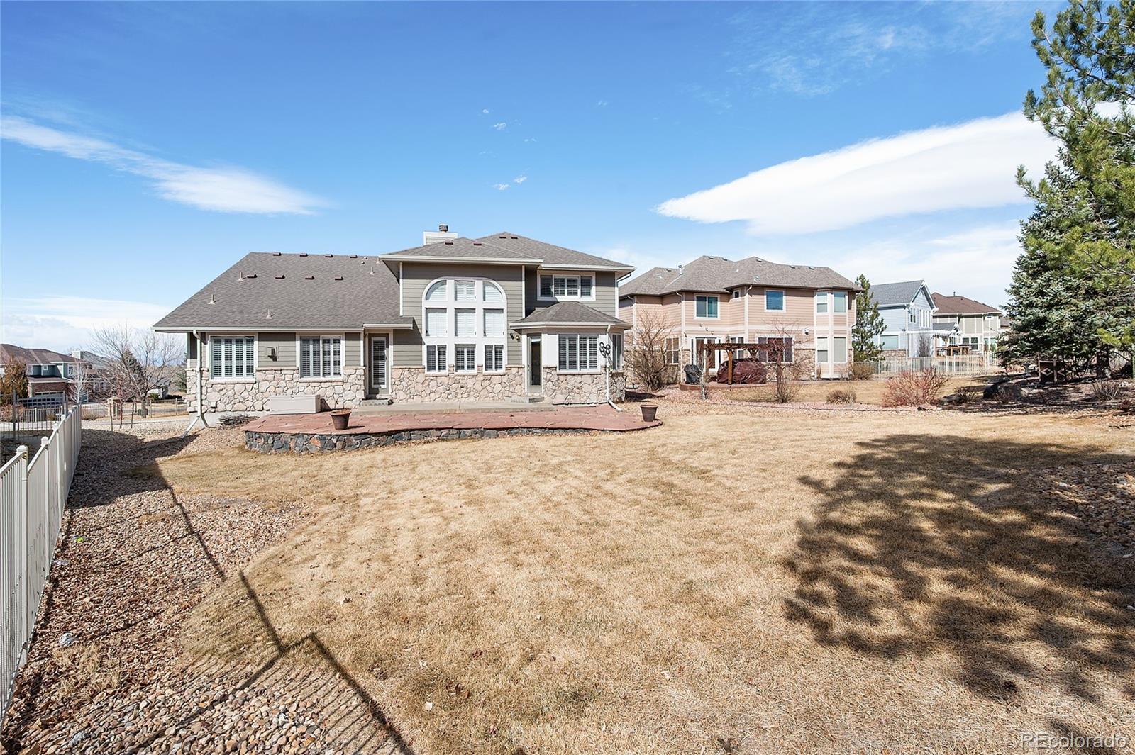 22426 East Roxbury Place Aurora, CO 80016 - Photo 43 of 50 a front view of a house with a yard