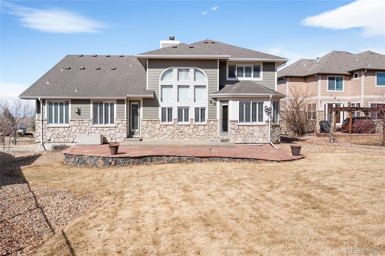 22426 East Roxbury Place Aurora, CO 80016 - Photo 44 of 50 a front view of a house with a yard