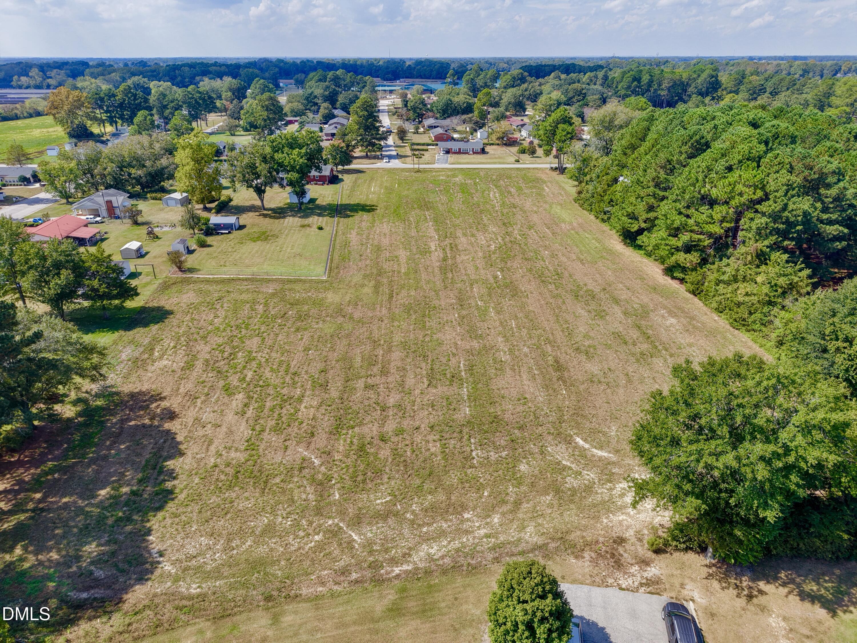 4.47-ac Fairground Road Dunn, NC 28334 - Photo 6 of 23 a view of a swimming pool with a lawn chairs and potted plants