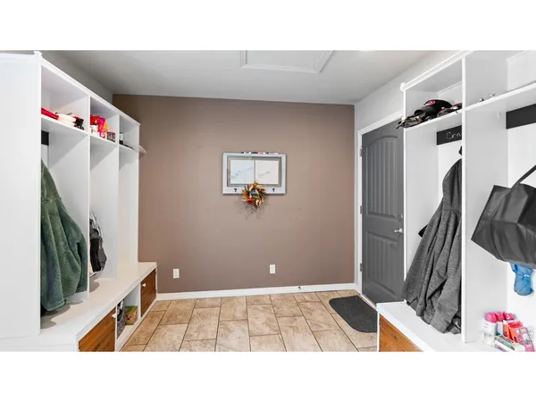 a kitchen with stainless steel appliances kitchen island granite countertop a refrigerator and a sink