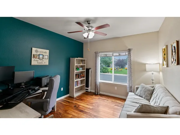 a living room with a bed furniture and a window