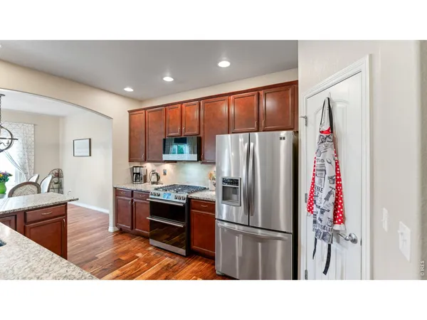 a kitchen with refrigerator cabinets and furniture