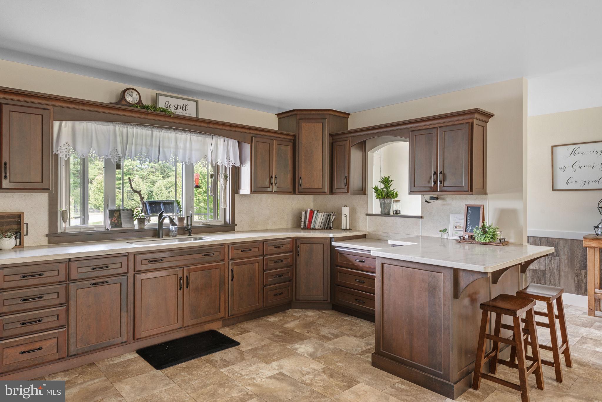 5382 Paes Road New Holland, PA 17557 - Photo 13 of 80 a kitchen with a sink white cabinets and wooden floor