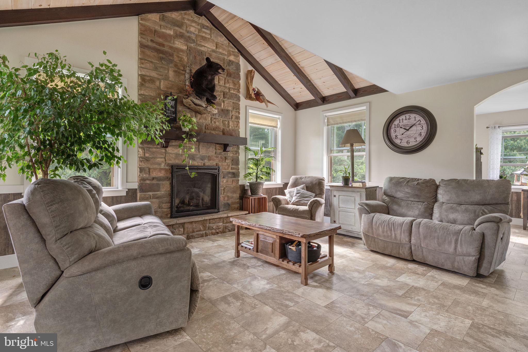 5382 Paes Road New Holland, PA 17557 - Photo 18 of 80 a living room with furniture a clock and a fireplace