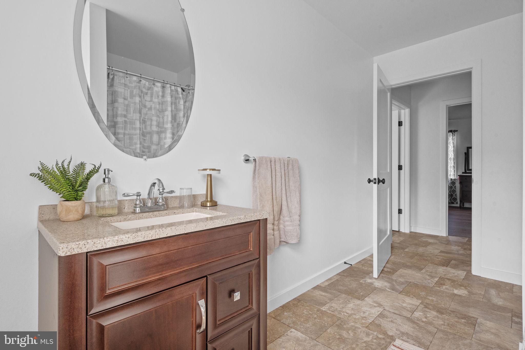 5382 Paes Road New Holland, PA 17557 - Photo 39 of 80 a bathroom with a granite countertop sink a mirror and a shower