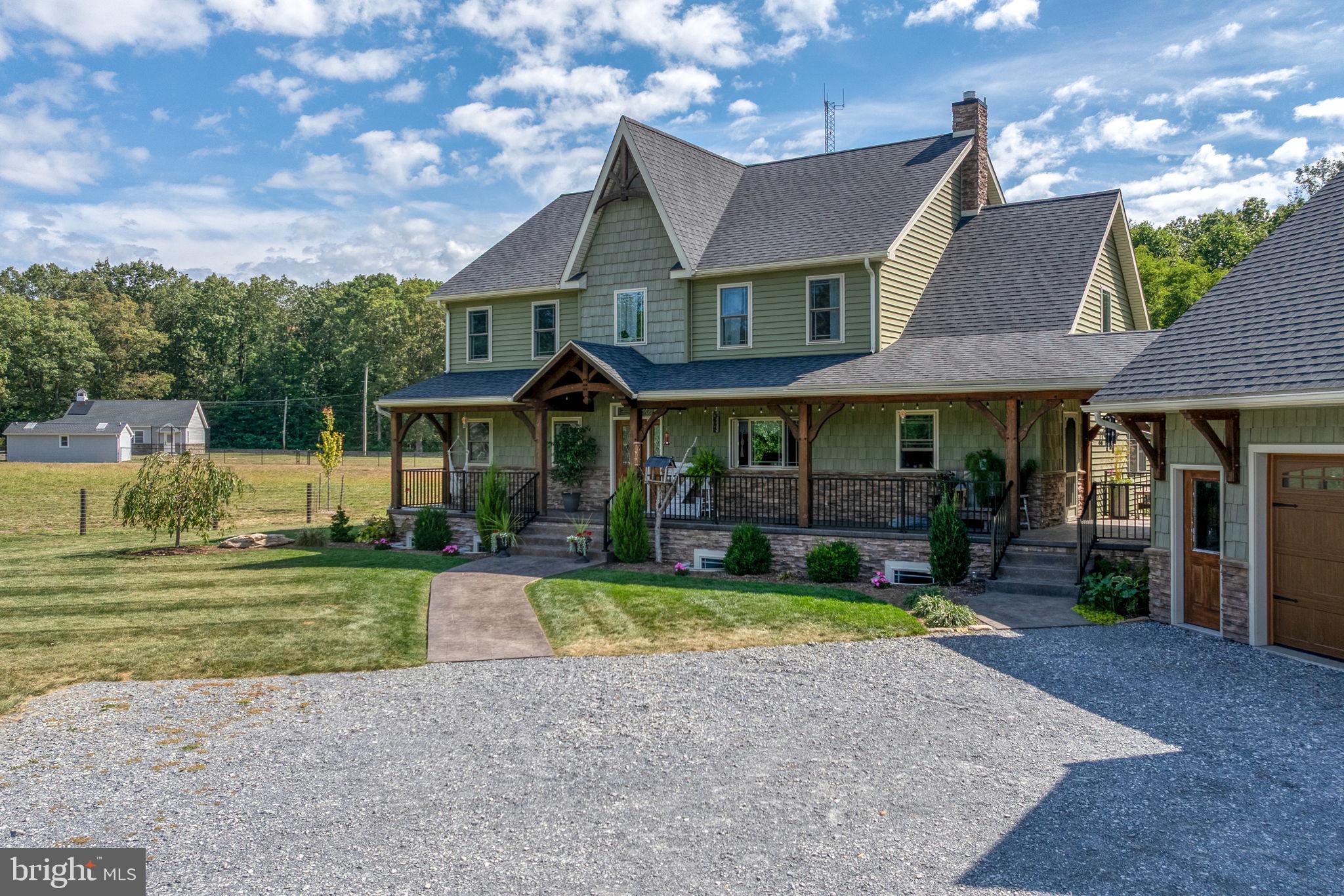 5382 Paes Road New Holland, PA 17557 - Photo 4 of 80 a front view of a house with a yard table and chairs